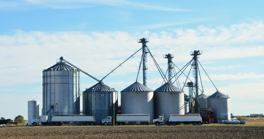 Grain silos and trucks at an elevator